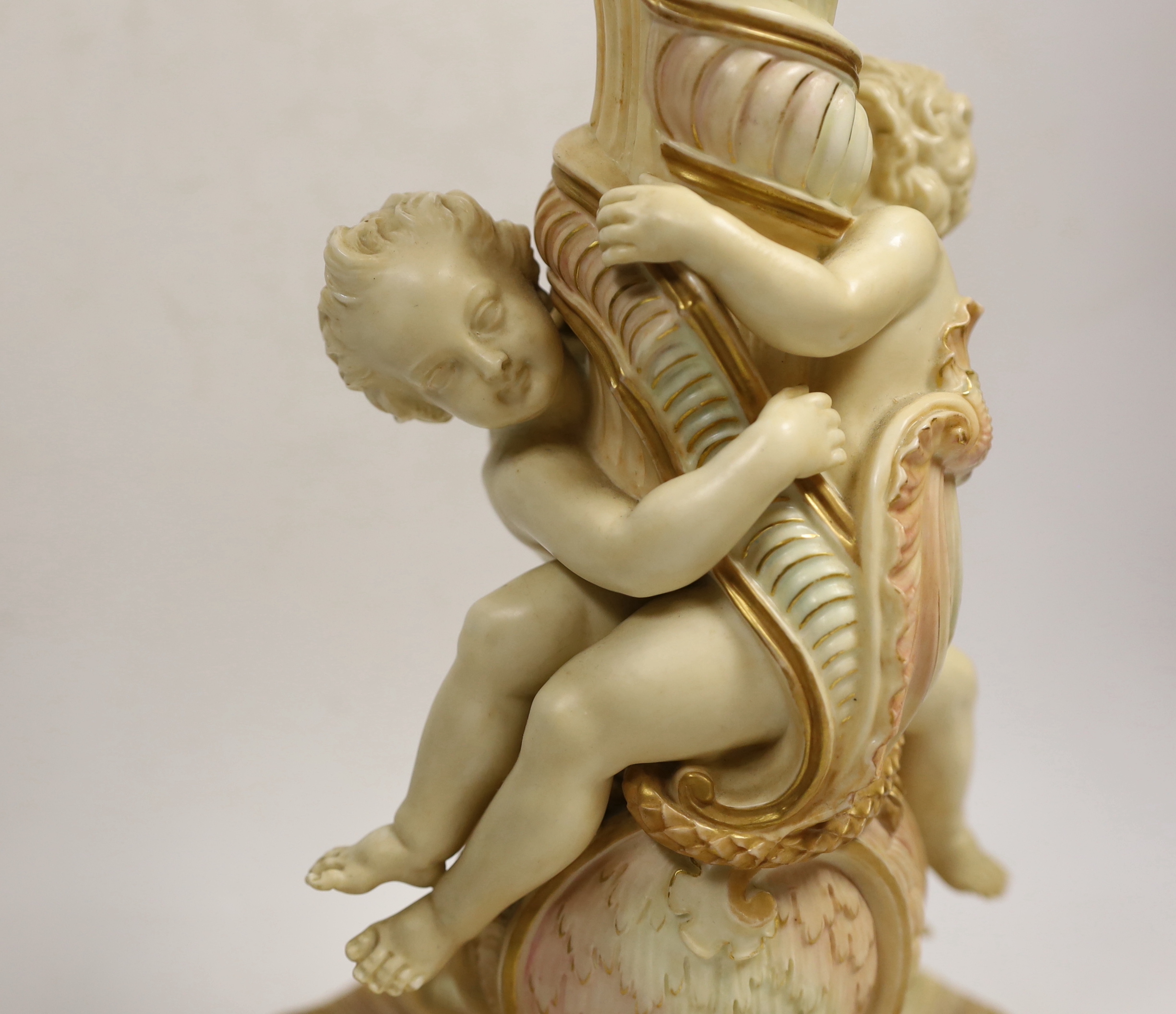 A large Royal Worcester blush ivory cherub lamp base, 40cms not including light fitting